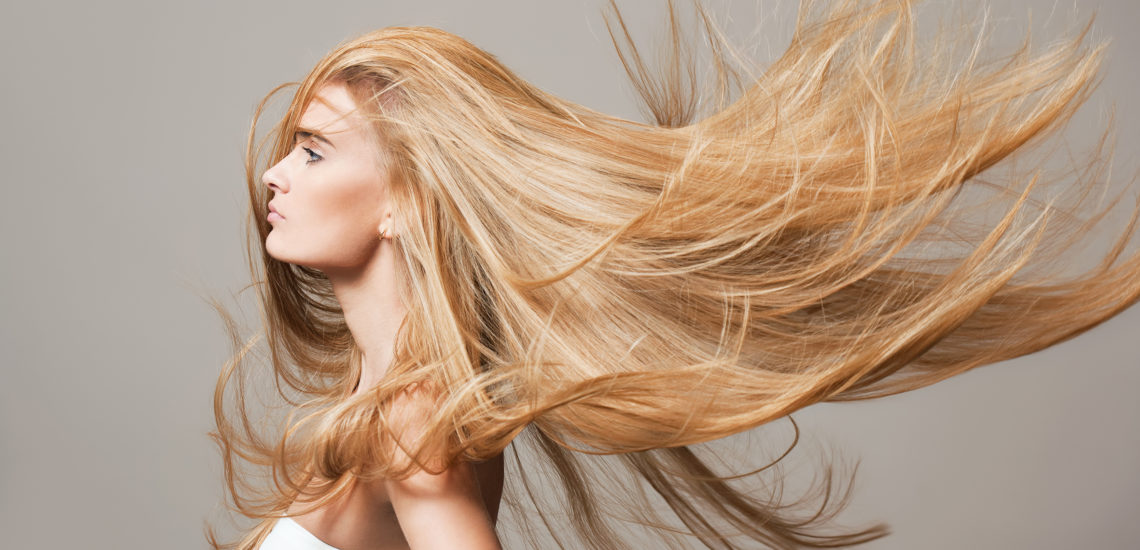 Portrait of a blond beauty with beautiful healthy long hair.